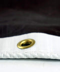 Close-up of brass grommet on HydraTarp Super Beefy Heavy Duty 16 Mil Tarp, 18 by 24 feet, white and brown reversible poly tarpaulin.