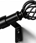 Close-up of matte black adjustable curtain rod 48 to 90 inches showing finial and bracket, heavy duty metal, holds up to 30 lbs.