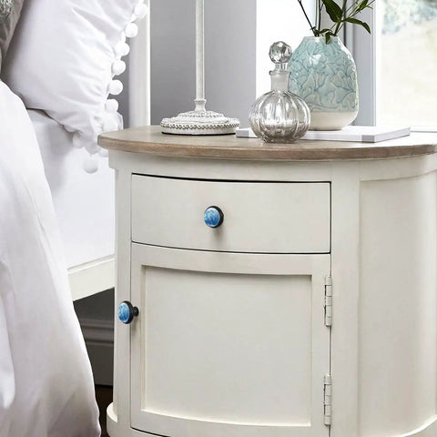 Marble Pattern Cabinet Knobs 4 Pack Round Single Hole Drawer Pulls For Kitchen Cupboards And Bedroom Drawers on a nightstand.