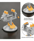 Versatile Mini Bench Vise With Suction Base For Jewelry And Electronics Repair Holds Small Parts Tight on Glass Or Wood Smoothly Without Drilling A Hole Compact Aluminum Alloy Clamp Tool Perfect For Detailed Work, showing suction base and aluminum jaws.