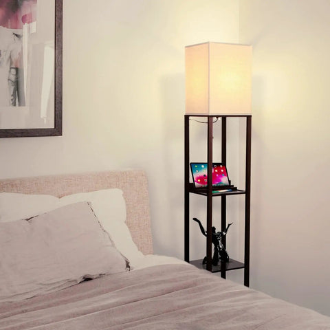 Maxwell Charger Shelf Floor Lamp With USB Ports And Electrical Outlet beside bed in bedroom, Havana Brown Finish, 9W 800-Lumen LED