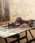 Badass Brushless 12 Volt Reciprocating Saw Kit With Quick Charge Battery on wood surface for demolition projects.