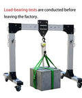 Game Changing Portable Gantry Crane 2204 Lbs Capacity Lightweight Aluminum Shop Hoist lifting a heavy block with green straps.