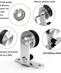 Side view of a top mount stainless steel barn door hardware kit including T style rails, rollers, and anti-falling wheel.