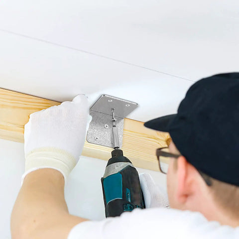 Person installing heavy duty 40 piece metal corner braces L brackets 2x2 inch for wood furniture home projects 90 degree right angle with drill