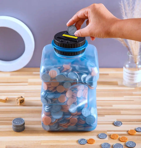 Hand inserting coin into Ultra Large Coin Bank With LCD Counter And 4.2L Capacity, Counts All US Coins And Displays Total Amount