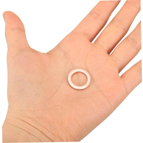 Copper Crush Sealing Washer from the assortment kit held in hand, suitable for car oil drain plugs and plumbing fittings.