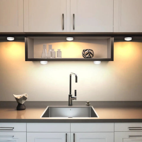 Color Changing LED Puck Lights With Remote, 6 Pack Stick On Battery Powered Under Cabinet Lighting, shown illuminating a kitchen.