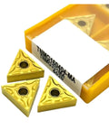 Three TNMG160404 carbide lathe tool inserts in a yellow case, designed for precision metal cutting and external turning.