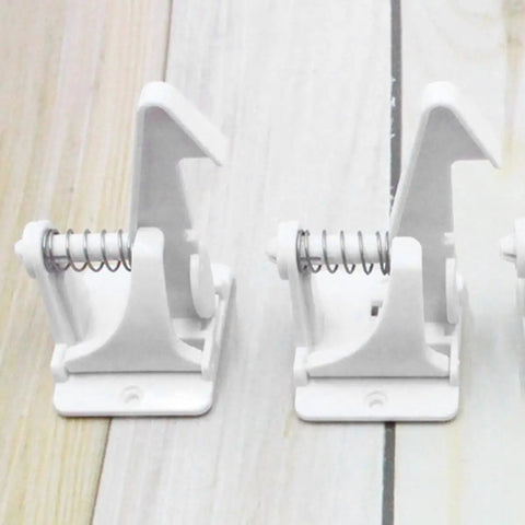 16 Piece White ABS Safety Cabinet Locks for dressers and freezers shown in close-up, highlighting the spring-loaded mechanism.