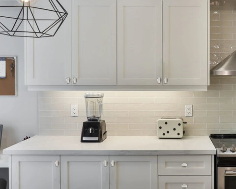 Brushed Satin Nickel Cabinet Knobs And Drawer Pulls Set, 25 Pack, installed on white kitchen cabinets and drawers.