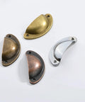Assorted metal cabinet pulls including Rustic Copper Half Moon Cabinet Pulls 12 Pack for drawers, dressers, and cupboards.