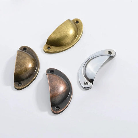 Assorted metal cabinet pulls including Rustic Copper Half Moon Cabinet Pulls 12 Pack for drawers, dressers, and cupboards.