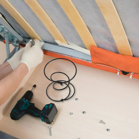 Person using a drill to install Rock Solid Heavy Duty Tension Springs 4 Pack Sofa Replacement Parts in couch repair.