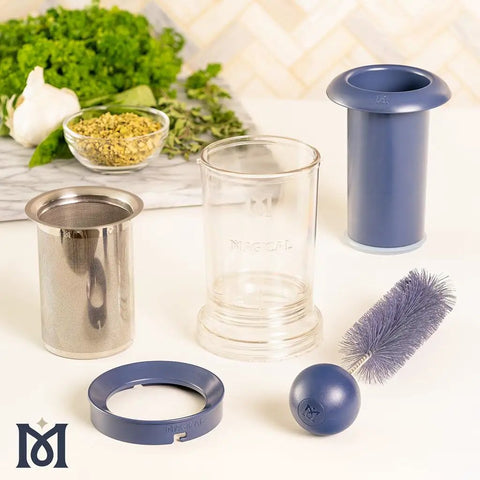 BPA-Free Reusable Oil And Butter Filter Press With Plunger And Brush, 75-Micron Stainless Mesh, components displayed on counter.