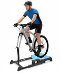Person cycling on Indoor Bike Trainer Platform Pro Roller with quick release front wheel in home gym setup