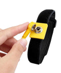 Person holding Anti Static Wrist Strap 11 Inch Adjustable ESD Wristband With Grounding Clip For Electronics And PC Building