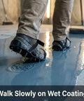 Person wearing Epoxy Floor Spiked Shoes With 1 Inch Spikes, 4 Pairs For Coating, Overlay And Resin Application, walking on wet floor