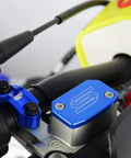 Blue front brake reservoir cap cover on motorcycle handlebar