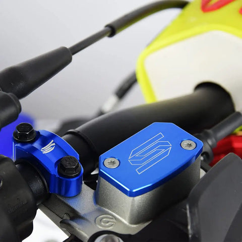 Blue front brake reservoir cap cover on motorcycle handlebar