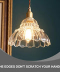 Clear Striped Glass Pendant Light Antique Brass Adjustable Mini Chandelier for Kitchen Island with smooth edges and a warm glow.
