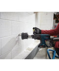 Person using Lightweight 18V Brushless SDS Plus Bulldog Rotary Hammer Bare Tool With Three Quarter Inch Chuck on brick wall