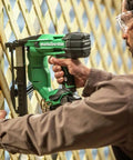 Person using Beast Of A 18V MultiVolt Cordless Stapler Kit With 1/4-Inch Narrow Crown on wooden lattice