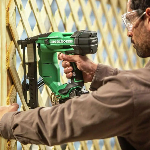 Person using Beast Of A 18V MultiVolt Cordless Stapler Kit With 1/4-Inch Narrow Crown on wooden lattice