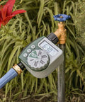 Automatic Garden Box Irrigation System Kit With 64 Sq Ft Coverage Digital Hose Timer connected to garden tap near plants