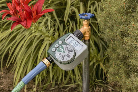 Automatic Garden Box Irrigation System Kit With 64 Sq Ft Coverage Digital Hose Timer connected to garden tap near plants