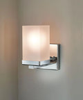 90 Degree Dual Mount 1 Light Chrome Bathroom Vanity Light With Frosted Glass Shade mounted on a wall, sleek design.