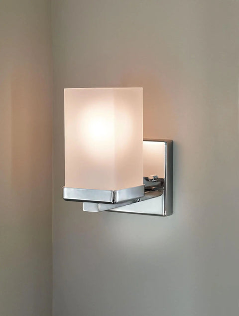 90 Degree Dual Mount 1 Light Chrome Bathroom Vanity Light With Frosted Glass Shade mounted on a wall, sleek design.