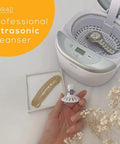 Professional Ultrasonic Cleaner With Digital Timer For Jewelry Rings Coins Eyeglasses Watches White 18.5 Fl Oz Fast Deep Clean For Everyday Grime And Tough Residue with a watch and jewelry displayed nearby.