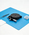 60Mm Manual Precision Rotation Stage Aluminum Platform R Shaft with tools on a blue mat for optical alignment projects.