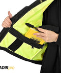Straight Up Durable High Visibility Class Two Safety Vest With Blazing Reflective Tape And Secure Zippered Pockets For Construction Crews And Surveyors In Fluorescent Yellow showing zippered pocket with notebook.