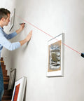Man using Line And Point Laser Level With 65 Ft Range, Two Bubble Vials, Batteries Included, And Versatile Mount For Easy Setup