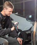 Person using MultiMatch R 1200 Lumen LED Work Light for painting jobs, providing bright light for car detailing.