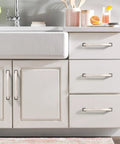 Slick Brushed Nickel Cabinet Pulls, 5 Inch Center To Center Kitchen Handles, 6 Pack With Quick Trim Mounting Screws on white drawers.