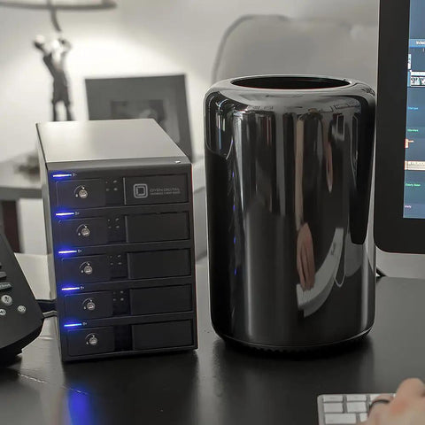 Five Bay Straight Shooter Storage Rig With No Sweat Setup Featuring Rock Solid Hardware beside a sleek black computer tower on a desk.