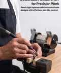 Mini Bench Grinder And Polisher With Variable Speed in use, flexible shaft engraving on ring for jewelry making on a workbench.