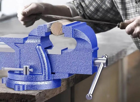 Heavy Duty 5 Inch Bench Vise With 360 Degree Swivel Locking Base Desktop Clamp in use on a workbench with metal file