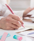 Person writing with pastel mechanical pencil set with six pencils 0.5 and 0.7 millimeter lead plus 360 HB lead refills erasers