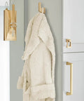Blackrock Champagne Bronze Cabinet Pull With 6 5/16 Inch Hole Spacing And Smooth Transitional Vibe That Gives Kitchen Drawers Bathroom Vanities Or Any Furniture Piece A Sick Home Glow Up Right Now, featuring a bathrobe on a hook.