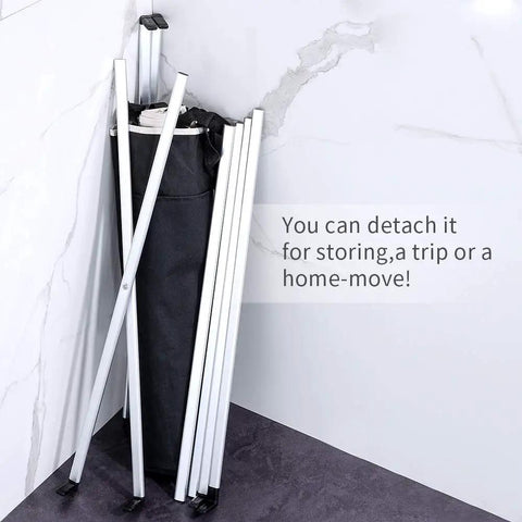 Folded Two Section Laundry Basket Hamper with Aluminum X Frame showing compact storage against a wall