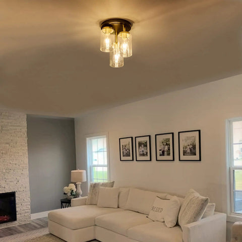 Three-Light Semi Flush Mount Ceiling Light Fixture With Dope Clear Glass Cylinder Shades In Gold Finish in living room