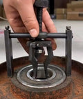 Inner Hole Bearing Puller With Three Claw Design for precise bearing removal in automotive repair, shown extracting bearing from hub.