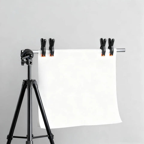 Five Pack Four And A Half Inch Spring Clamps For Backdrops And Crafts securing white backdrop on stand