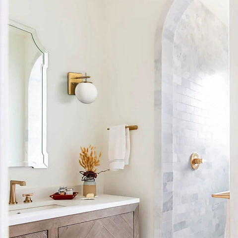 Gold Globe Wall Sconces Set of Two, Dope Brass Modern Vanity Lights With Milky White Glass Shades in bathroom setting