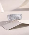 Fresh Drip Platinum Plated Moissanite Grid Engagement Ring Featuring A Smooth Wide Band And Lab Grown Diamond Sparkle Set In Solid Certified 925 Sterling Silver Ring For Her on a soft background.