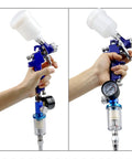 Badass Performance HVLP Mini Paint Spray Gun With Integrated Pressure Regulator And 125 Ml Gravity Cup featuring handholding for precise paint work.